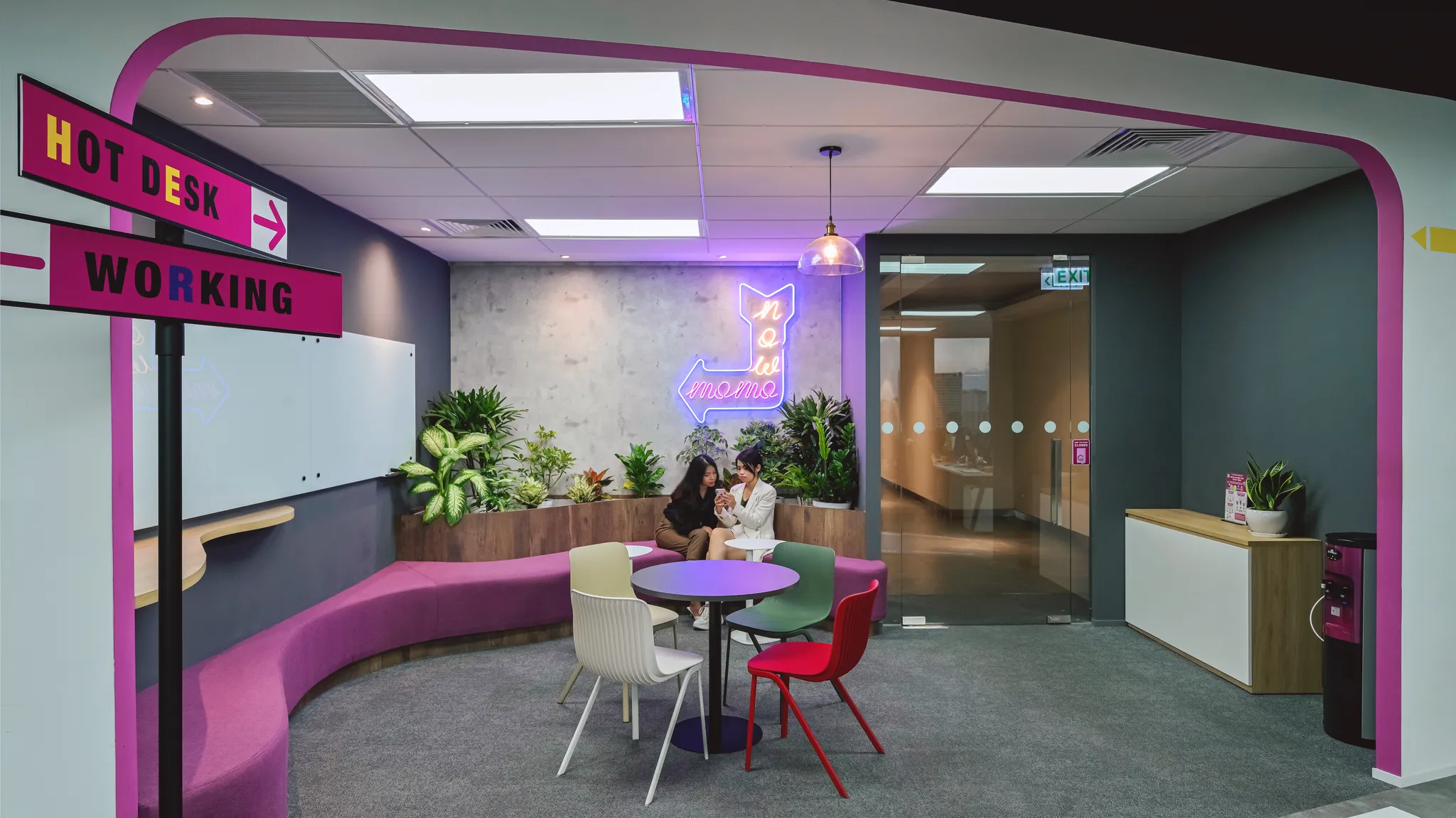 <figcaption>A collaborative area in the Momo office using brand color and greenery elements.</figcaption>